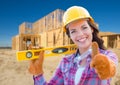 Happy Female Construction Worker with Thumbs Up Holding Level Wearing Royalty Free Stock Photo