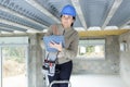 female construction worker with toolkit and ladder