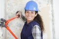 female construction worker using boltcutters