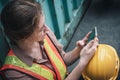 Female Construction Worker Using Mobile Phone While Resting in Workshop Warehouse, Close-Up of Logistics Woman Labor Used