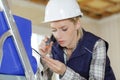 Female construction worker using screwdriver to connect wires Royalty Free Stock Photo