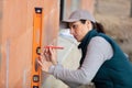 female construction worker using vertical spirit level Royalty Free Stock Photo