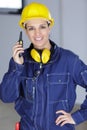 female construction worker using walkie-talkie Royalty Free Stock Photo