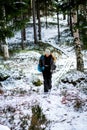 Female content creator hiking in winter forest Royalty Free Stock Photo