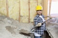 Female contractor digging sand at construction site Royalty Free Stock Photo