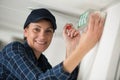 female contractor installing illuminated exit sign Royalty Free Stock Photo
