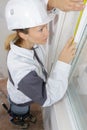 female contractor measuring window Royalty Free Stock Photo
