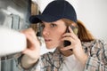 female contractor taking voice call on smartphone