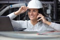 female contractor using laptop in roofspace Royalty Free Stock Photo