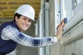 female contractor using spirit level on window sill Royalty Free Stock Photo