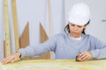 Female contractor using tape measure Royalty Free Stock Photo