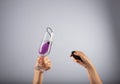 Female controlling the purple sex toy vibrator in the champagne glass with water