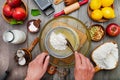 female cook adds flour to a glass bowl through a sieve. Cooking dough for a pie top view. Cream with eggs in glass bowl Royalty Free Stock Photo