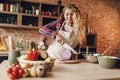 Female cook in apron cutting fresh vegetables Royalty Free Stock Photo