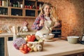 Female cook in apron prepares fresh salad Royalty Free Stock Photo