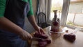 Female cook in an apron with is preparing a sweet pepper stuffed with meat in kitchen. Girl fills peppers with minced meat and put