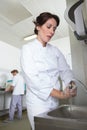female cook cleaning hands Royalty Free Stock Photo