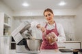 female cook hands pouring melted chocolate into tray. she is preparing sweet cake Royalty Free Stock Photo