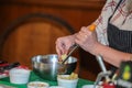 A female cook holds a grater and a cheese grater