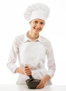 Female cook pounding something using mortar and pestle Royalty Free Stock Photo