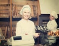 Female cooks with fresh and tasty bread in bakery