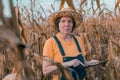 Female corn farmer using digital tablet in cornfield, smart farming Royalty Free Stock Photo