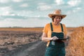 Female corn farmer using digital tablet in cornfield, smart farming Royalty Free Stock Photo