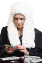 Female corrupt judge counting money at table on white