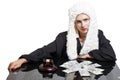 Female corrupt judge with gavel and money at table