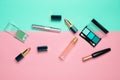 Female cosmetics for make-up layout on a pastel background. Cosmetic shadows, make-up brush, eyeshadow lipstick, perfume bottle. Royalty Free Stock Photo