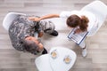 Female Councilor Consoling Soldier At Her Clinic Royalty Free Stock Photo