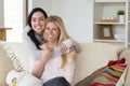 Female couple cuddling at home