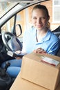 Female Courier In Van Delivering Package To Domestic House Royalty Free Stock Photo