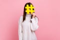 Female covering face with social media hashtag symbol, recommending to follow trendy content, blog.