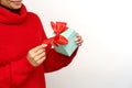 Female in cozy sweater open gift box. African woman hold christmas present. Seasonal winter sales Royalty Free Stock Photo