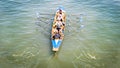 Female crew is training on a rowing boat in venice canal.