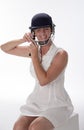Female cricketer putting on safety helmet