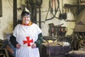 Female crusader in a workroom