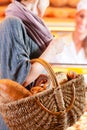 Female customer with breadbasket in bakery