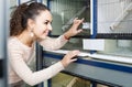 Female customer buying new bird in pet shop