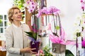 Female customer choosing potted orchid