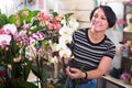 Female customer choosing potted orchid