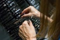 Female customer hands choosing eyelash brushes and eyeliners.