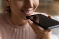 Female customer hold phone speak audio request to assistant app