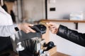 Female customer making wireless or contactless payment using credit card. Closeup of human hands during payment. Store Royalty Free Stock Photo