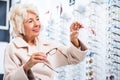 Female customer in optician store Royalty Free Stock Photo