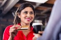 Female Customer paying for coffee with credit card Royalty Free Stock Photo