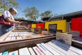 A female customer peruses an open air used book stall in Cogolin, Var, France