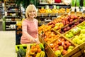 Female customer purchasing at supermarket, choosing fruits Royalty Free Stock Photo