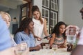 Female Customer In Restaurant Paying Bill Using Contactless Credit Card Terminal Royalty Free Stock Photo